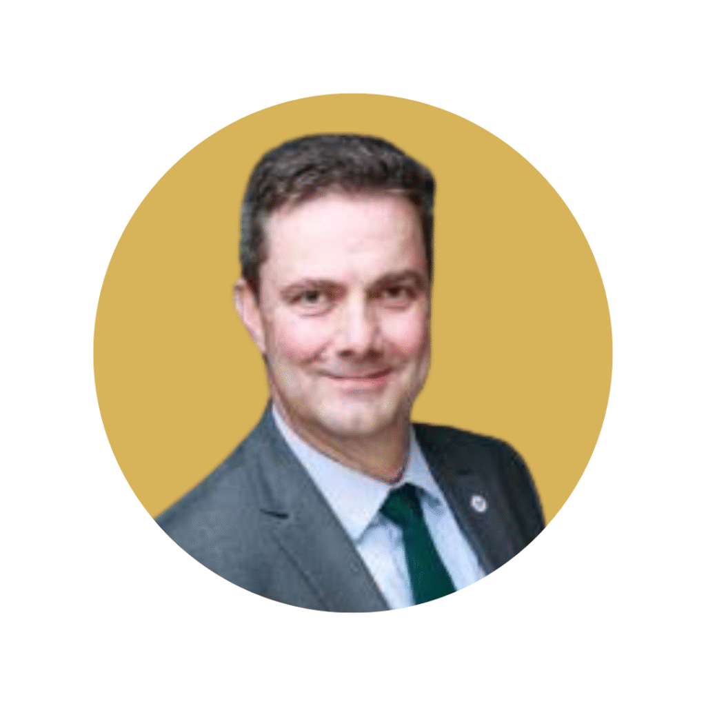 Mark Arnul. Man with dark hair and suit smiling towards camera