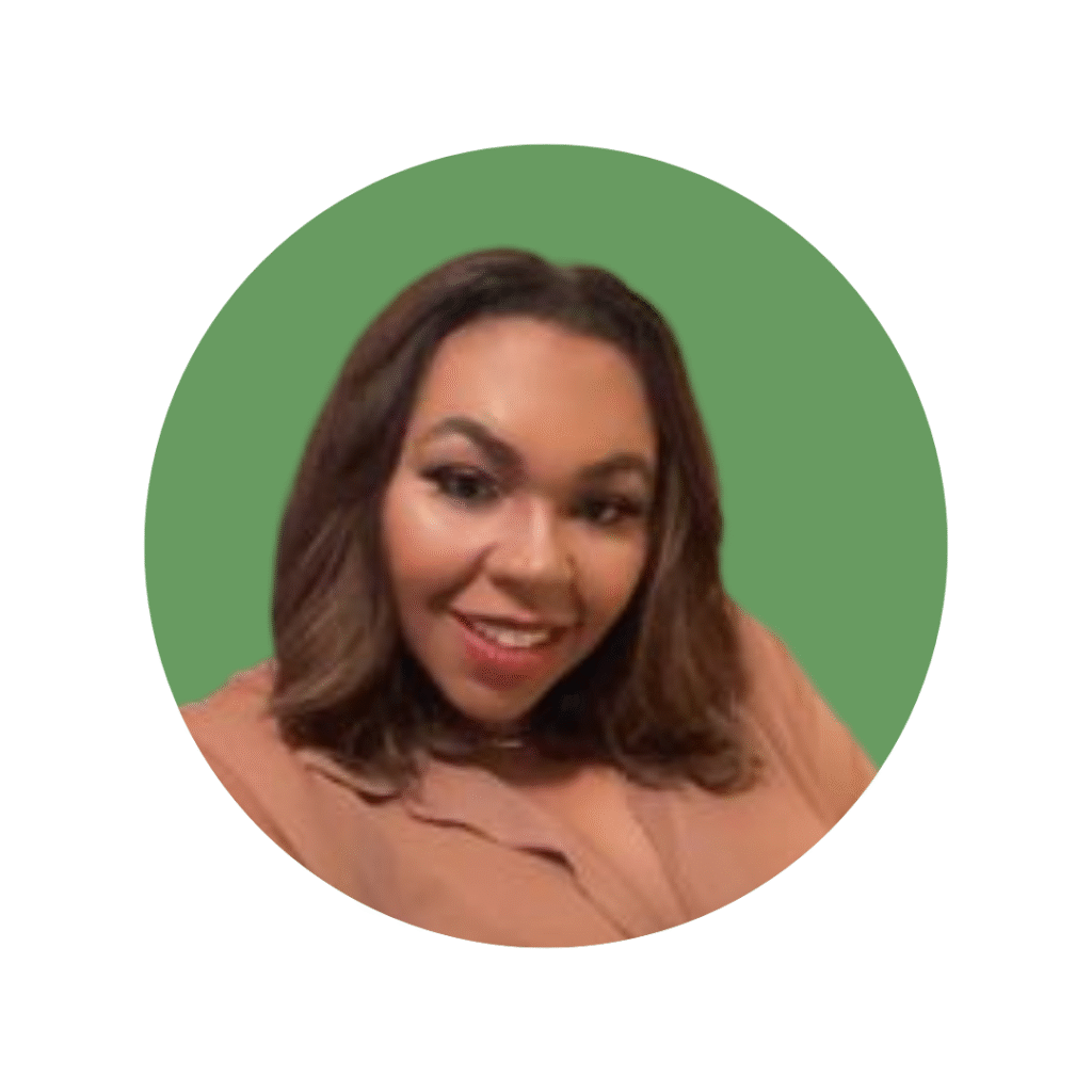 Woman with shoulder length dark hair with shirt on, smiling at camera