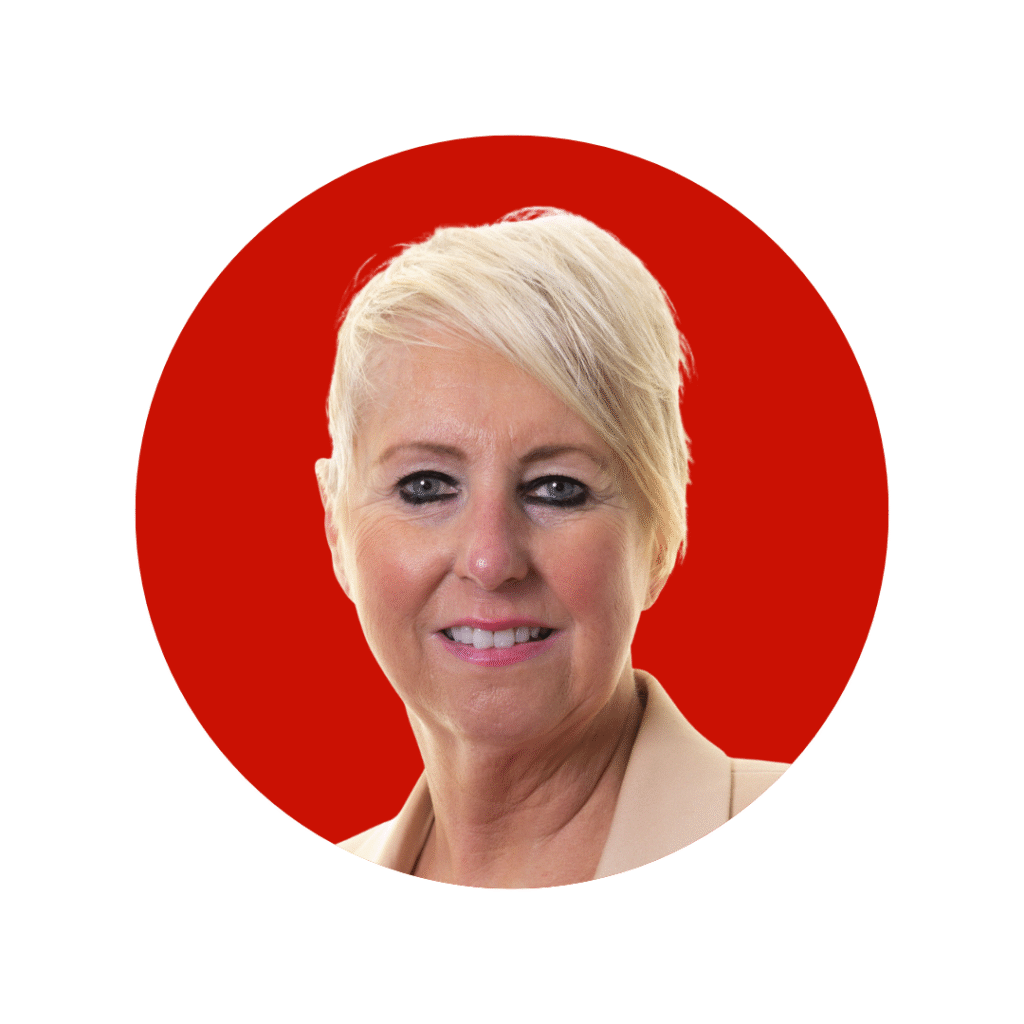 Woman with short blonde hair in suit jacket smiling