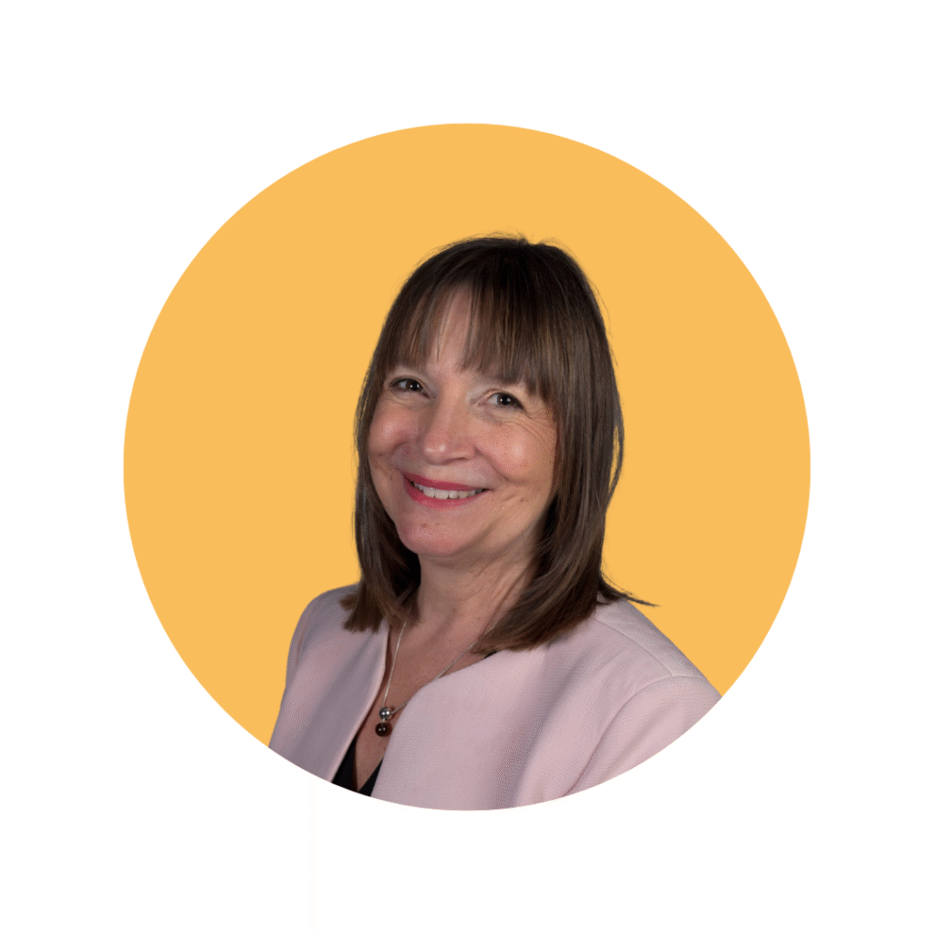 woman with dark hair in suit smiling towards camera
