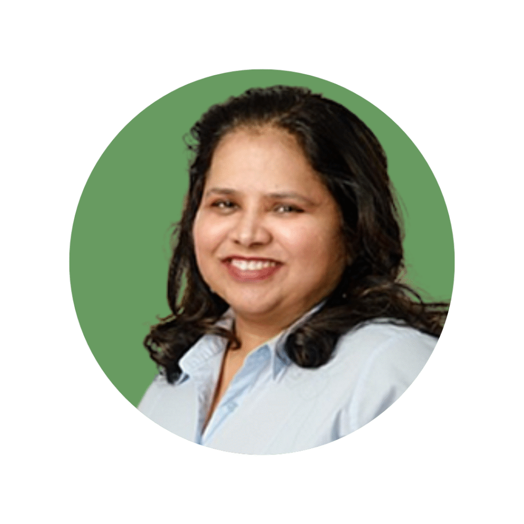 Woman in light shirt and mid length dark hair smiling towards camera