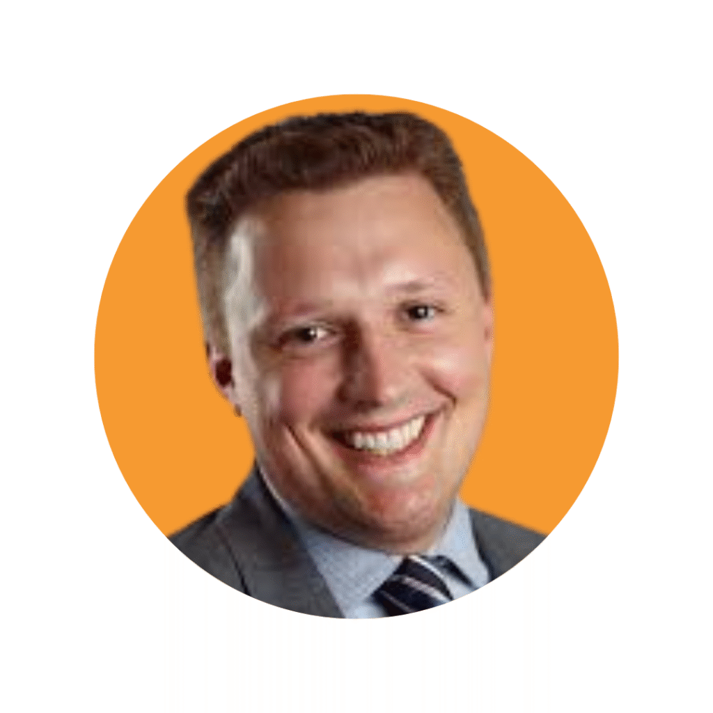 Man with short hair in suit smiling at camera