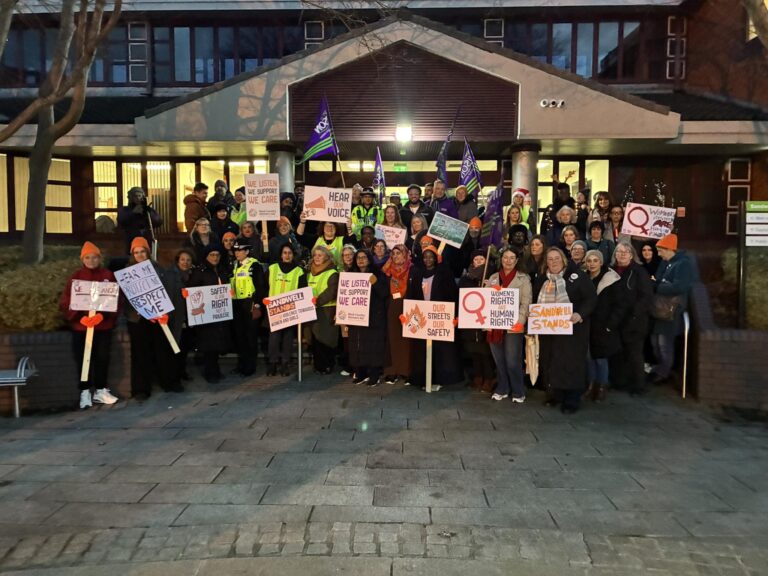 Group of men and women stood with placards and messages, together with police officers, outside of the Sandwell Council House in Oldbury ahead of the Sandwell Stands Reclaim the Night Walk