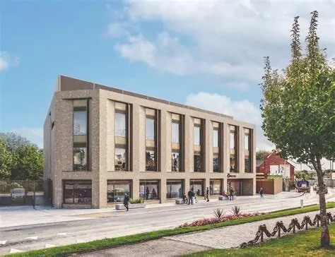 Design drawing of the Cradley Heath Skills Campus. Light brown bricks and long windows, with walk ways and road in front.