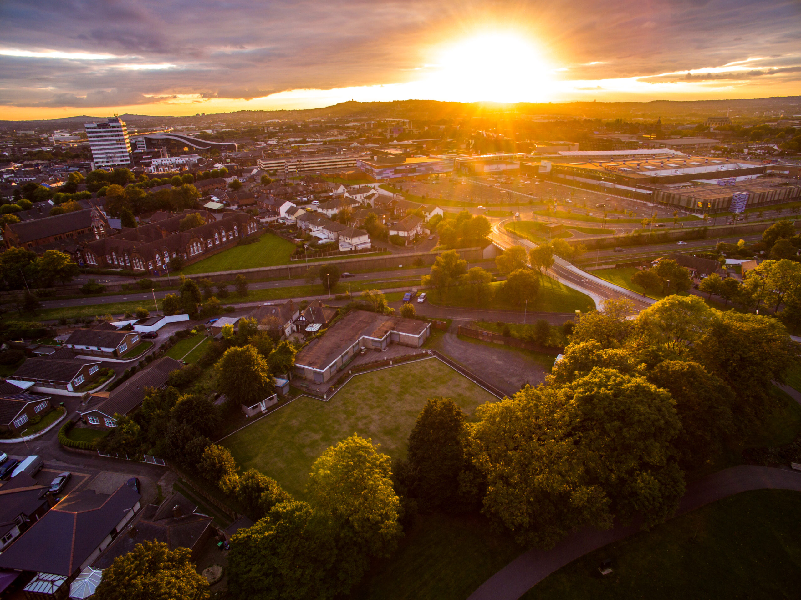 Aerial shot of West Bromwich and surrounding areas. You can see parks, lots of trees and the outline of the college. The sun is just setting
