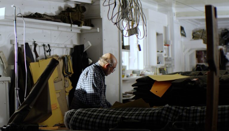 Bhulla's father in his textiles factory in Smethwick, setting out pieces of material