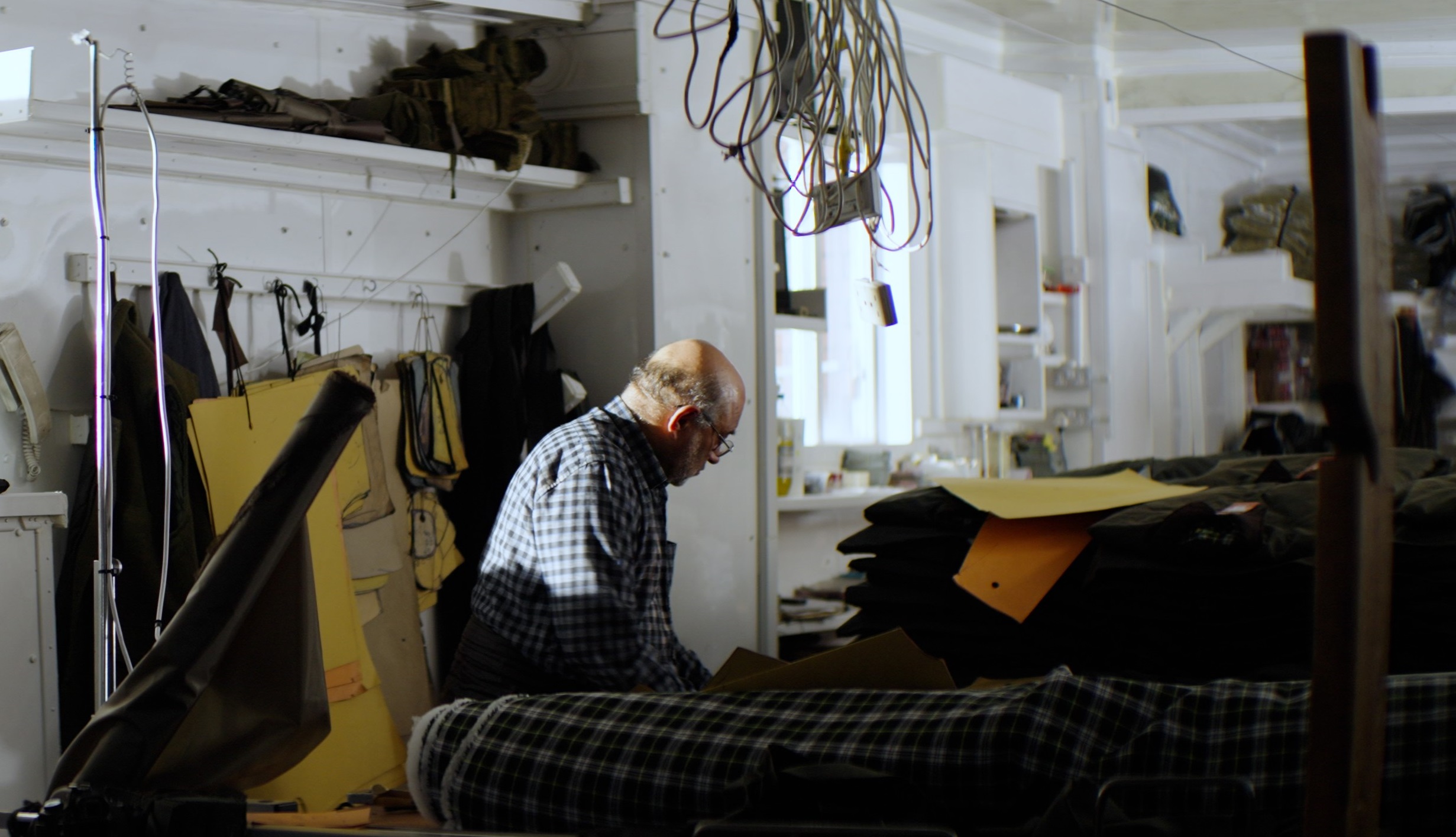 Bhulla's father in his textiles factory in Smethwick, setting out pieces of material